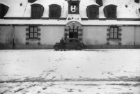 CHAMARANDE. - Château, vue en perspective d'une voiture stationnée dans la cour des communs enneigée, un militaire allemand pose devant le véhicule [v. 1940 - 1944 ; don de M. Heinrich Heill] ; noir et blanc ; 12 cm x 8, 5 cm (2010). 